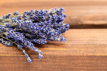 Bouquet of lavender flowers on a wooden background. Place for text. Selective focus.