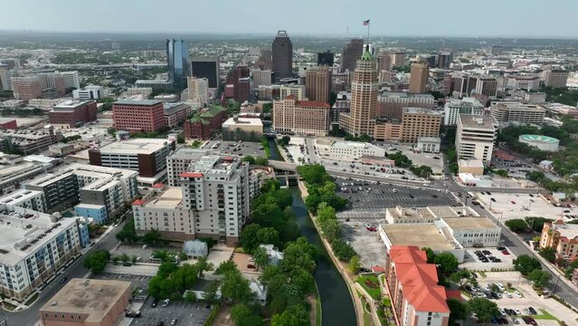 Downtown San Antonio skyline. Descending aerial with Riverwalk.