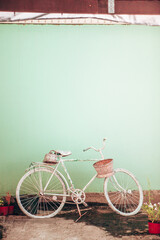 Vintage vertical card with colored bicycle and mint green background