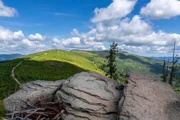 Malinowska rock on the background of mountain landscape and sky and clouds