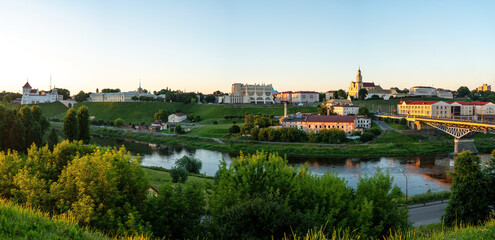 Fototapeta na wymiar GRODNO, BELARUS JULY 1, 2022: Panoramic view of the historical center of Grodno at sunset. Beautiful city and embankment along the river.