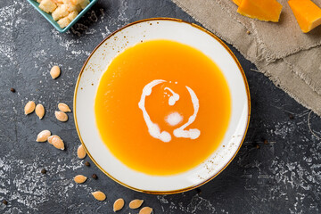 Soup cream of pumpkin top view on grey table