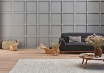 Grey room decorative wall background, dark blue sofa, middle table, blanket pillow style, vase of...