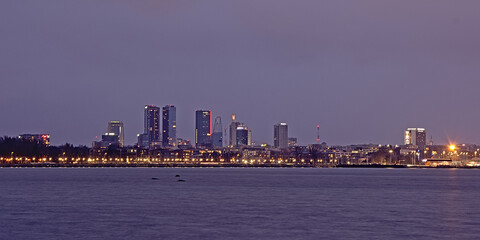 Fototapeta premium Nocturnal view on skyscrapers of the modern district of the city of Tallin,Estonia from across the Baltic sea.