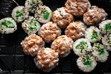 Delicious sushi rolls with tuna, cucumber and avocado. Traditional Japanese sushi is ready to eat