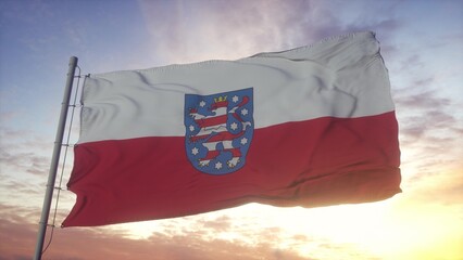 Thuringia flag, Germany, waving in the wind, sky and sun background. 3d illustration
