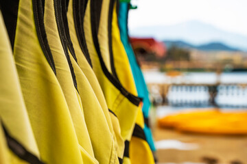 Row of life jacket hanging for tourist services. Selective focus.