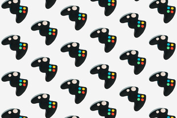 Seamless pattern with gamepads on white background. Creative concept of video game or gaming...