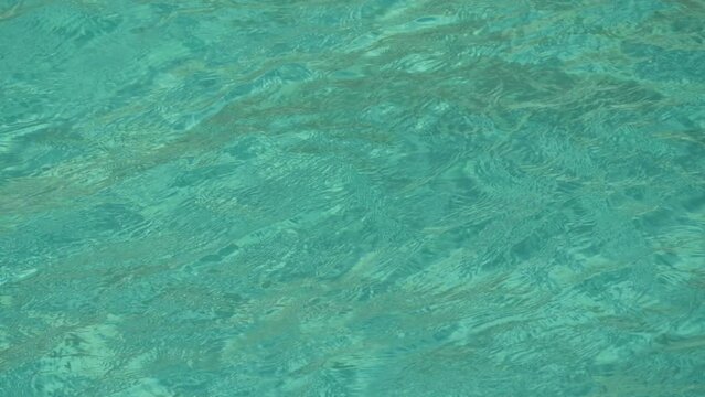 Transparent turquoise water of the Cretan Sea on the shore and a huge tourist ship