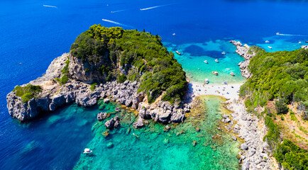 Corfu island best beaches, Greece . Aerial drone view of beautiful double beach with turquoise clear waters Limni beach Glyko near Paleokastritsa.