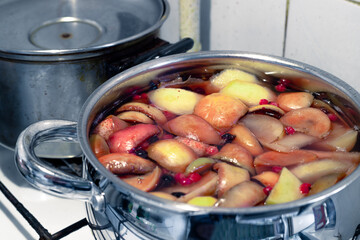 Fruit compote in a bowl. Fresh and tasty compote. Preparation of a healthy fruit compote in a chrome pan