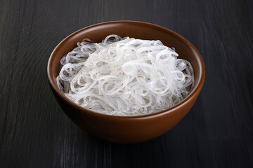 Rice glass noodles in a bowl on a dark background. With clipping path.
