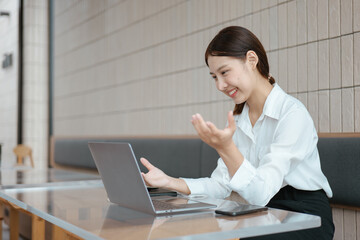 Young business women working and greeting on video conference with happy and smile face on office...