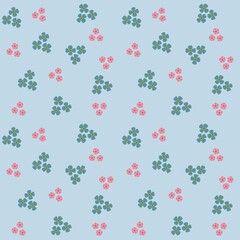 Cute seamless pattern with Isolated blue and pink small flowers on the light blue background.