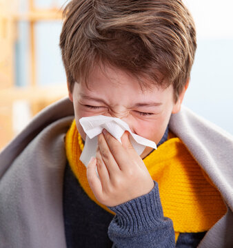 Teen Boy get cold and blow her nose at home.