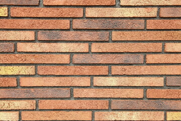 Textured wall of red narrow and long bricks. Decorative styles for wall decoration. Background,...