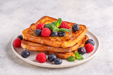 French toast with blueberries, raspberries, maple syrup