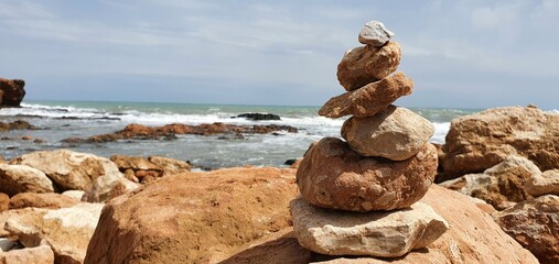 Tower of stones on the background of the sea. Stone tower balance.