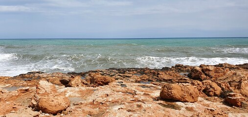 Beautiful sea in Spain.
Stone coast of the sea. Marine background. Sea waves on the rocks.