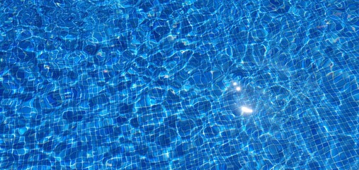 Clean water in the pool. Blue water in the pool. Clear water in the pool. Swimming pool background.