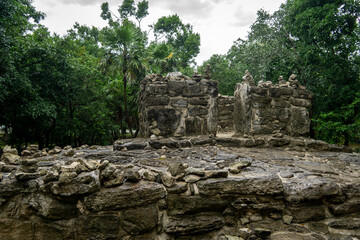 The ruins of an ancient Mayan altar against the backdrop of a gloomy forest in a thunderstorm. Mayan stone buildings, Yucatan, Mexico