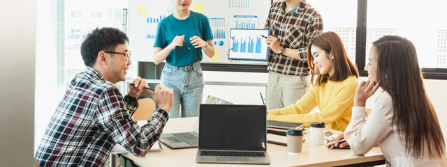 Start up partners discussing the ideas for new strategy of development at nice near the white board...