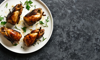 Roasted quails on plate