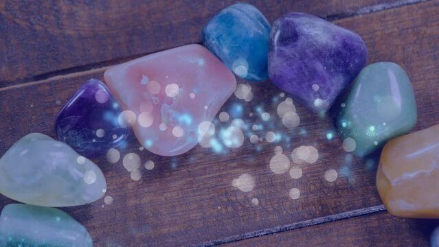 Animation of dots blinking over stones on wooden surface