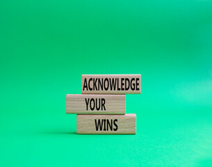 Acknowledge your wins symbol. Concept words Acknowledge your wins on wooden blocks. Beautiful green background. Business and Acknowledge your wins concept. Copy space