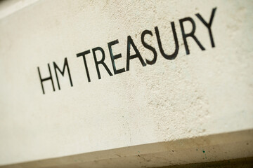 Angled view of HM TREASURY sign on Whitehall building in London, UK.