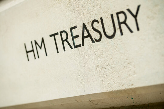 Angled view of HM TREASURY sign on Whitehall building in London, UK.
