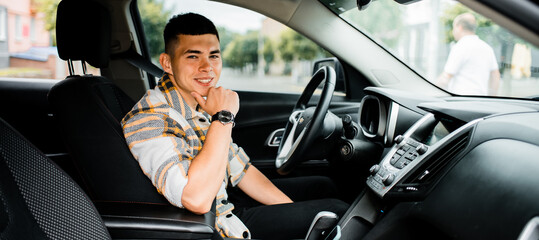 Portrait of a young man in a car