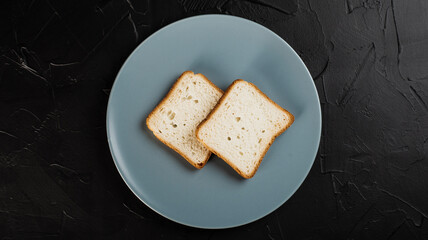 Two slices of bread on a plate. The concept of lack of food.