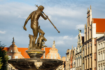 Obraz premium Gdansk, Poland with Neptune fountaine statue. Famous place and tourist attraction in travel destination. European old town at Baltic sea