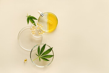 CBD oil in pipette, THC tincture in laboratory round cups and marijuana leaves on light background