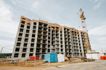 cranes at the construction site of European-style houses with multiple entrances