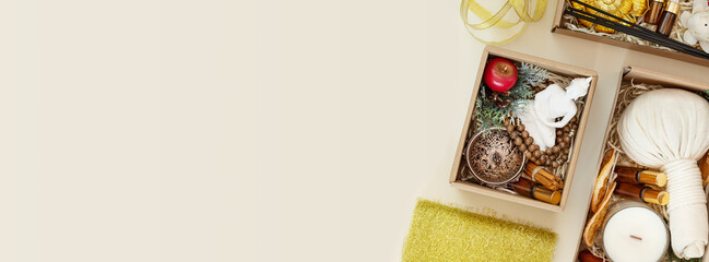 Holiday banner with gift boxes with candles, aroma sticks, natural oils, decorations and copy space. Making Christmas sets for meditation, relaxation and self-care. Surprise for Christmas and New Year