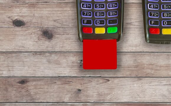 credit card machine and credit card on wooden table
