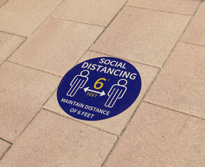 Social distance sign enamel painted with stencil on the floor
