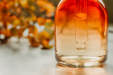 Natural cosmetics, serum in a bottle with a close-up. Spa and bio autumn skincare concept