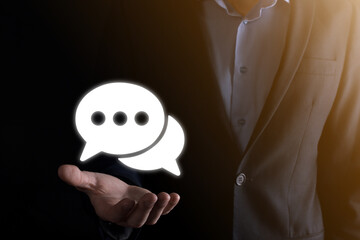 Businessman holding a message icon, bubble talk notification sign in his hands. Chat icon, sms...