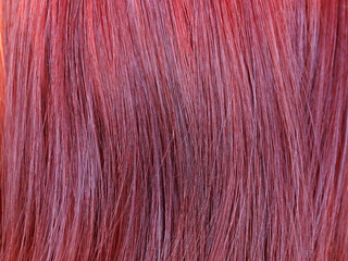 dyed red female hair closeup, texture for background