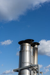 Side view of a Galvanized metal chimneys exhaust with a rain cap