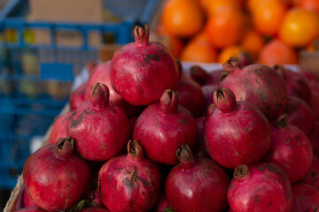 Red ripe pomegranate on the counter of a street vegetable store