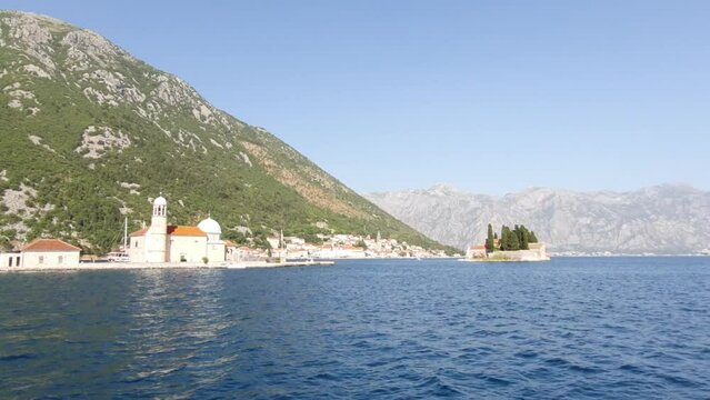 Island of St. George, church on island, Madonna on reef, near town Perast in Bay Kotor, Montenegro. Beautiful high mountains near sea in Montenegro. Place for sea tourism, sports, recreation