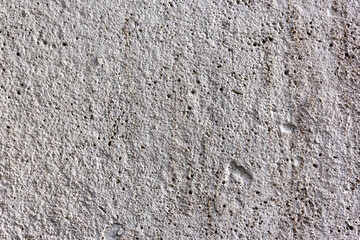 Rough concrete wall for the background. Cement wall texture for the background. Covering the foundation of house walls with cement plaster. Grey surface for design. Construction technologies