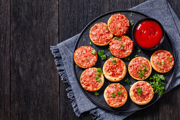 mini pizzas with ham and pecorino cheese, top view