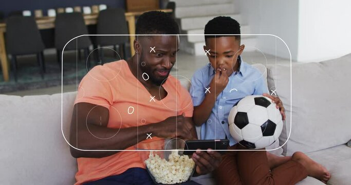 Animation of soccer field over african american father and son watching match in smartphone