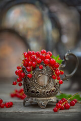 Redcurrant in an old silver cup, vintage style. Soft, selective focus.
