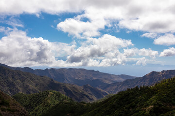 Valley of Garajonay National Park covered in clouds. View from Roque de Agando in  on La Gomera, Canary Islands, Spain, Europe. Mountain and hill landscape. Hiking trail on sunny day in summer